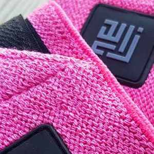 Close-up view of ZLCOPENHAGEN's naughty pink wrist wraps recycled, showcasing intricate details and eco-friendly craftsmanship.