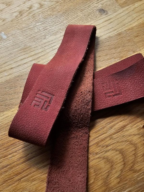 Upcycled leather lifting straps made from repurposed leather scraps from the football production and leather apparel industries in Sialkot, showcasing durability and eco-friendliness
