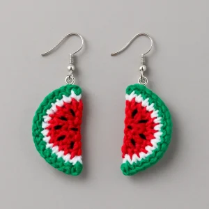 Crochet watermelon earrings on a light grey background