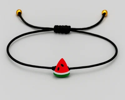 Free Palestine watermelon charm bracelet on a slim black cord by ZLCOPENHAGEN on a light grey background